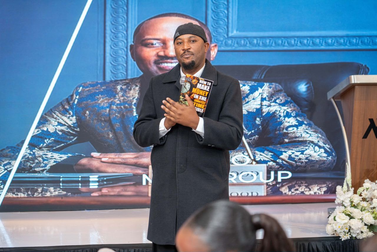 Mudiwa Hood on stage presenting his book