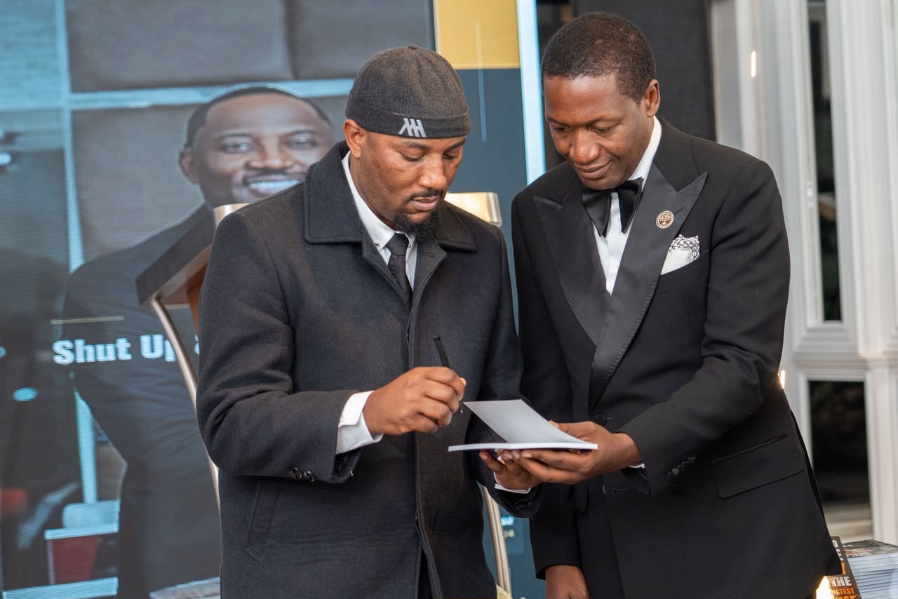 Mudiwa Hood signing a copy for a guest